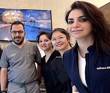 Experienced Chicago Dentists at DentalQ Lincoln Park DentalQ Lincoln Park dentists Dr. Rusul and Dr. Arash smiling with their dental assistants, representing experienced Chicago dental care.